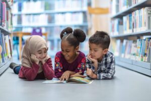 Students reading on the floor of a library